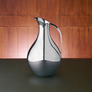 Sterling Silver bellied jug featuring a curved handle and a stylish polished finish.