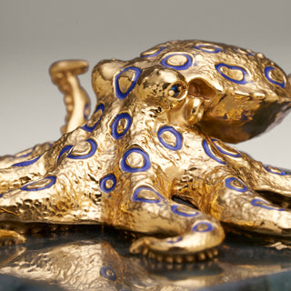 Sterling silver Blue Ringed Octopus sculpture with blue enamel, yellow gold plating and sapphire eyes, mounted on a labradorite stone base.