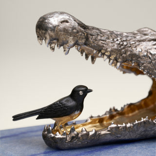 Patinated sterling silver crocodile sculpture with gold and black ruthenium plating, sapphire eyes and a Willy Wagtail with diamond eyes, mounted on a blue aventurine stone base.